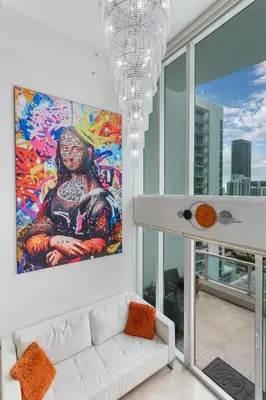 a living room with a couch and a painting on the wall at Brickell Miami LUXURY LOFT 2bd 2bth, Sleeps 6, Garage Parking, Walk to HOTTEST Restaurants & Nighlife in Miami