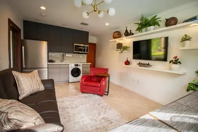 a living room with a couch and a red chair at Sunset in Sunset