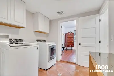 a kitchen with a washer and dryer in it at 3 Home 12 bedroom compound with Pool and BBQ sleeps 24 in Miami