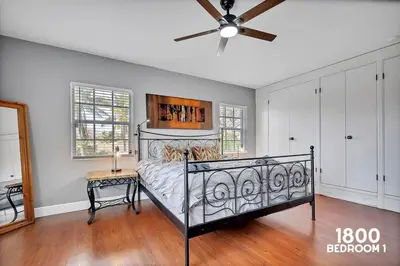 a bedroom with a bed and a ceiling fan at 3 Home 12 bedroom compound with Pool and BBQ sleeps 24 in Miami
