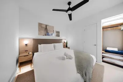 a bedroom with a white bed with a teddy bear on it at 1-BD Condo in DTW Miami - City Views in Miami