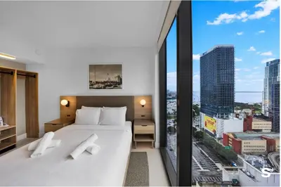 a hotel room with a bed and a large window at Modern Downtown Studio with city views in Miami