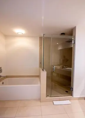 a bathroom with a tub and a glass shower at Penthouse Vacation Beach Resort in Hollywood