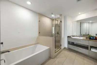 a white bathroom with a tub and a sink at Penthouse Vacation Beach Resort in Hollywood