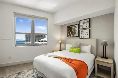 a bedroom with a large bed and a window at Penthouse Vacation Beach Resort in Hollywood