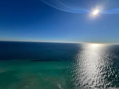 an aerial view of the ocean with the sun in the sky at Penthouse Vacation Beach Resort in Hollywood