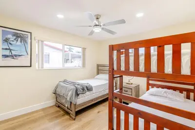 a bedroom with two bunk beds and a ceiling fan at Luxury Retreat Near Hard Rock in Joe Robbie Stadium Heliport