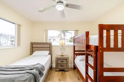 a bedroom with two bunk beds and a window at Luxury Retreat Near Hard Rock in Joe Robbie Stadium Heliport