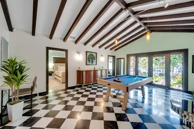 a pool table in the middle of a room at Magnificent Tropical Pool Home Miami SouthBrickell in Miami