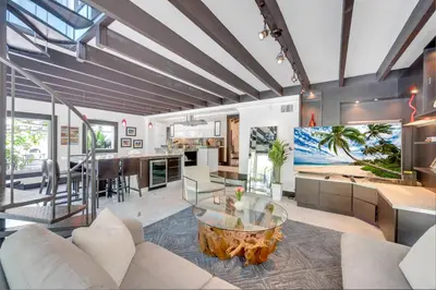 a living room with a glass table in the middle at Magnificent Tropical Pool Home Miami SouthBrickell in Miami