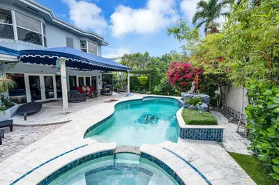a swimming pool in the backyard of a house at Magnificent Tropical Pool Home Miami SouthBrickell in Miami