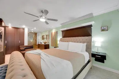 a bedroom with a large bed and a couch at Magnificent Tropical Pool Home Miami SouthBrickell in Miami