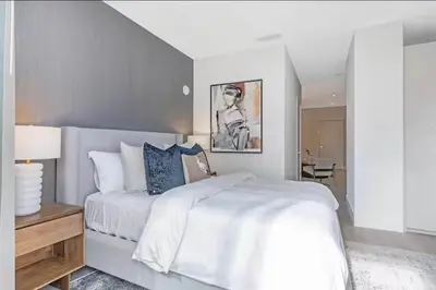 a white bedroom with a large bed and a table at Modern Brickell Luxe Apartment by Palermo Home Miami in Miami