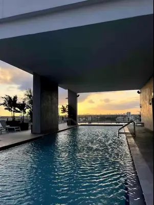 a swimming pool in a building with a sunset in the background at Modern Brickell Luxe Apartment by Palermo Home Miami in Miami