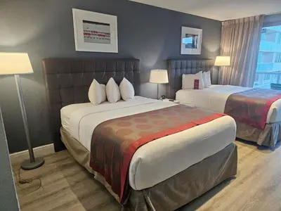 a hotel room with two beds and two lamps at Ocean front paradise studio with ocean view and beach exit in Sunny Isles Beach