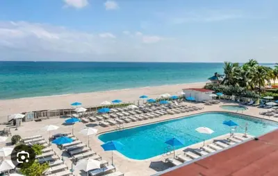 an aerial view of a resort with a swimming pool and the beach at Beach Studio with City View in Sunny Isles Beach