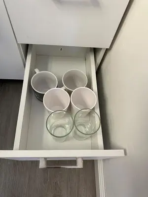 three bowls on a shelf in a cabinet at 2 Nice and Cozy guest house in Opa-locka