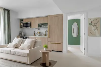 a living room with a white couch and a kitchen at 3701 Kaseya Center 2 Bdr Apt with Pool and Gym in Miami