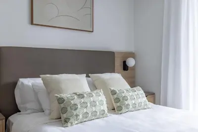a bed with white sheets and pillows on it at 3701 Kaseya Center 2 Bdr Apt with Pool and Gym in Miami