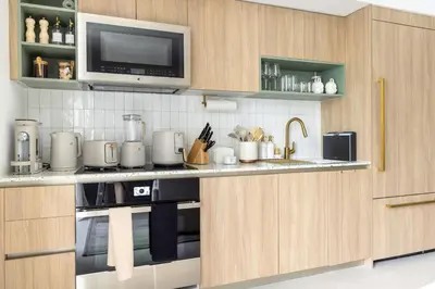 a kitchen with a stove and a microwave at 3701 Kaseya Center 2 Bdr Apt with Pool and Gym in Miami