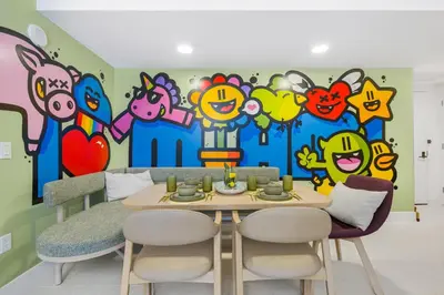 a dining room with a painting on the wall at 3005 golden305 2BR Apt mins to Wynwood and Brickell w Pool a Gym and PS5 in Miami