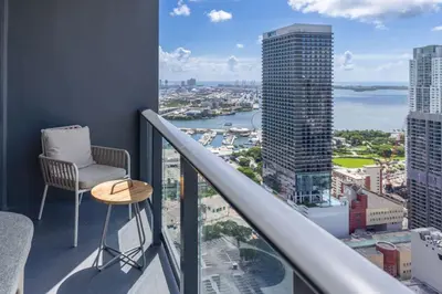 a balcony with a chair and a view of a city at 3610 Calm Blue Studio w Balcony View Pool and Gym in Miami