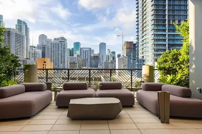 a balcony with couches and a view of a city at 3610 Calm Blue Studio w Balcony View Pool and Gym in Miami