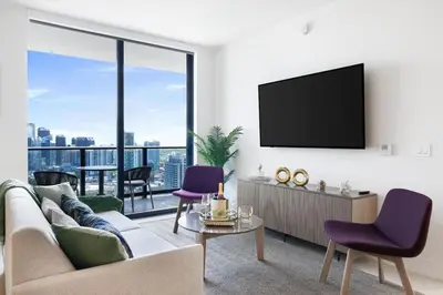 a living room with a couch and a tv at 4305 High Floor Apt with City and Marina Views in Miami