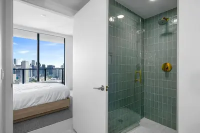 a bedroom with a shower with green tiles at 4305 High Floor Apt with City and Marina Views in Miami