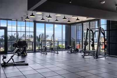 a gym with treadmills and machines in a building at 4305 High Floor Apt with City and Marina Views in Miami