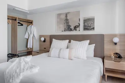 a bedroom with a large bed with white sheets at 3209 Apt in Heart of Downtown with Pool a Gym and Spa in Miami