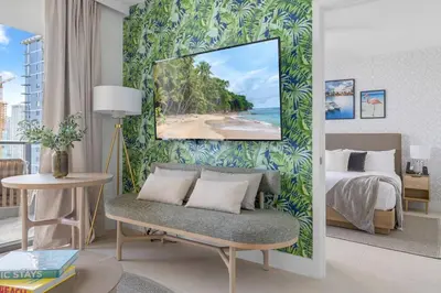a room with a bedroom with a bed and a beach at 2414 Chic Stay in Miami Downtown with Bay and City Views a Pool and Gym in Miami