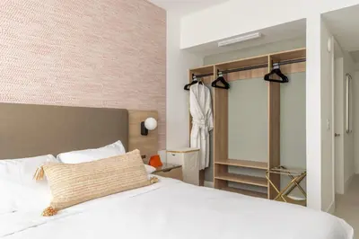 a bedroom with a white bed and a brick wall at 3615 Luxury Condo for 8 people with Gym and Pool in front of Kaseya Center in Miami