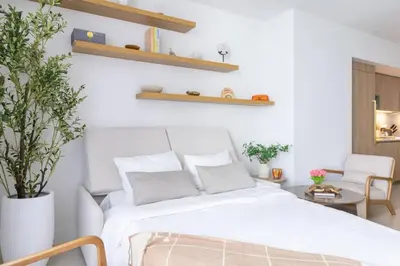 a bedroom with a white bed and a chair at 3615 Luxury Condo for 8 people with Gym and Pool in front of Kaseya Center in Miami