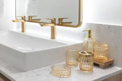 a bathroom sink with gold faucet and glasses on a counter at 3615 Luxury Condo for 8 people with Gym and Pool in front of Kaseya Center in Miami