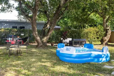 a blue and white inflatable pool in a yard at Wynwood beautiful Art Deco home with 4 Bedroom in Miami
