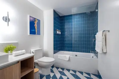 a bathroom with a tub and a toilet and a sink at 2012 New Apt with Pool and Gym in front of Kaseya Center in Miami