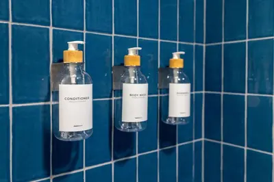 a group of bottles on a blue tiled wall at 2012 New Apt with Pool and Gym in front of Kaseya Center in Miami