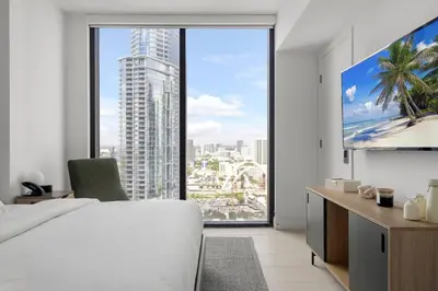 a bedroom with a large window with a view of a city at 3013 Kaseya Center Apt for 4 people with Pool and Gym in Miami