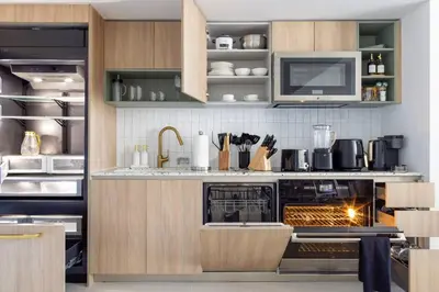 a kitchen with wooden cabinets and an oven at 3013 Kaseya Center Apt for 4 people with Pool and Gym in Miami