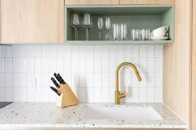 a kitchen counter with a sink and wine glasses at 2901 Beautiful Downtown Apt with Pool and Gym in Miami