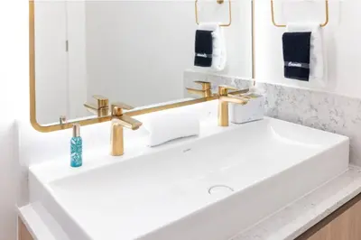 a bathroom with a white sink and two mirrors at 2901 Beautiful Downtown Apt with Pool and Gym in Miami