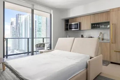 a bedroom with a bed and a large window at 2901 Beautiful Downtown Apt with Pool and Gym in Miami