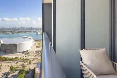 a room with a balcony with a view of a stadium at 2409 Apt in Downtown Miami with Gym and in front of Kaseya Center in Miami