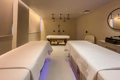 two beds in a hospital room with a sink at 2409 Apt in Downtown Miami with Gym and in front of Kaseya Center in Miami