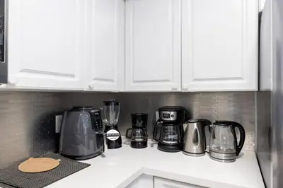 a kitchen counter with various appliances on a counter top at Aventura Mall Apt with Pool a Tennis Court and Free parking in Aventura