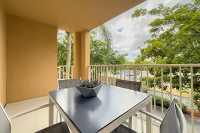 a table and chairs on a balcony with a view at Aventura Mall Apt with Pool a Tennis Court and Free parking in Aventura