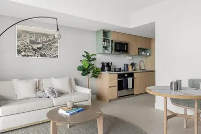 a living room with a couch and a table at 3808 Apt Next to Kaseya Center with Pool a Spa and Gym in Miami