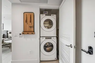 a laundry room with a washer and dryer at 3312 Modern Apt in front of Kaseya Center with Pool and Gym in Miami