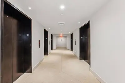 a hallway with black and white walls and a long corridor at 3312 Modern Apt in front of Kaseya Center with Pool and Gym in Miami